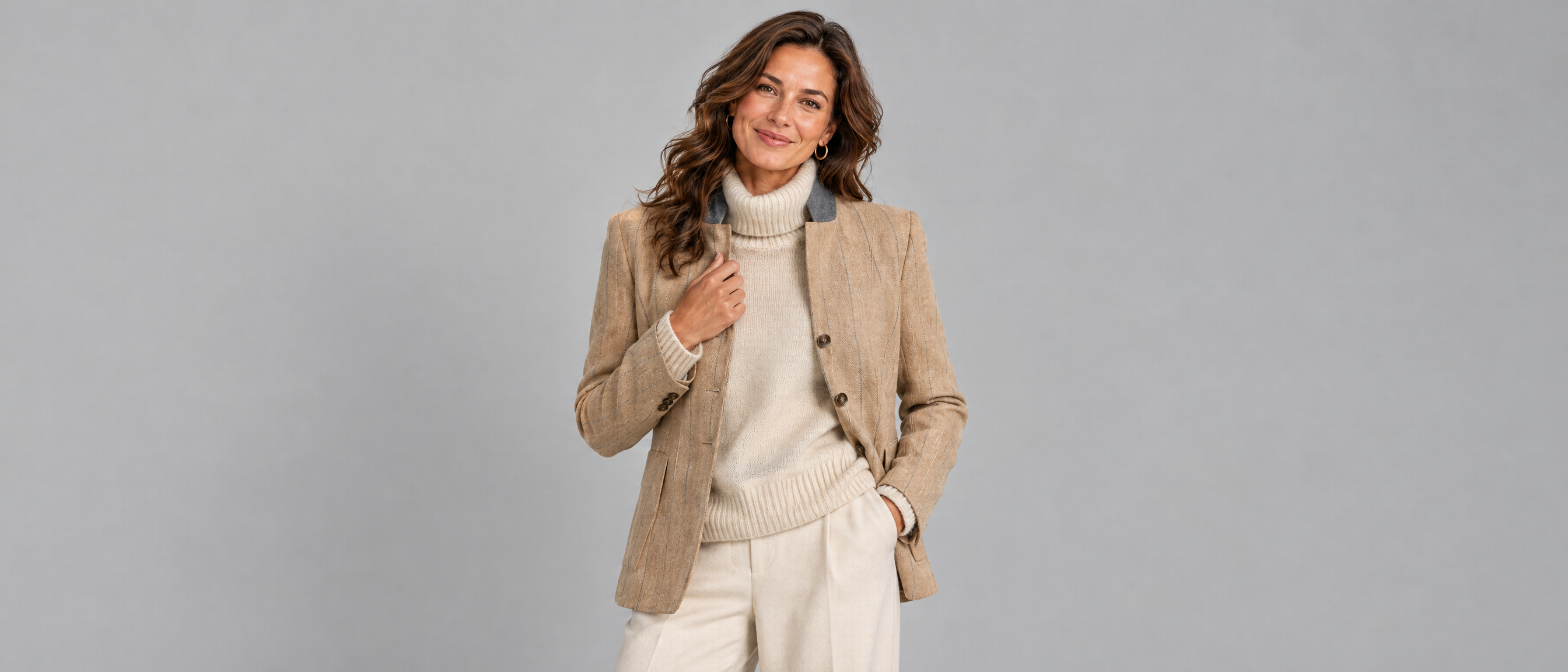 Woman wearing the Voxelvu pinstripe blazer over a roll neck jumper