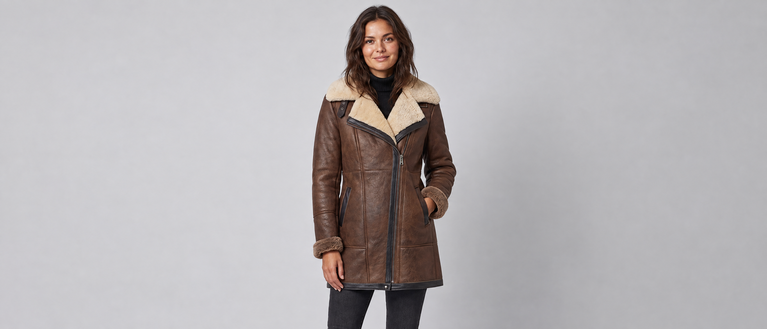 Woman wearing the Voxelvu aviator coat in a grey studio