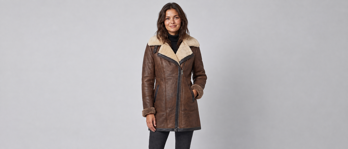 Woman wearing the Voxelvu aviator coat in a grey studio