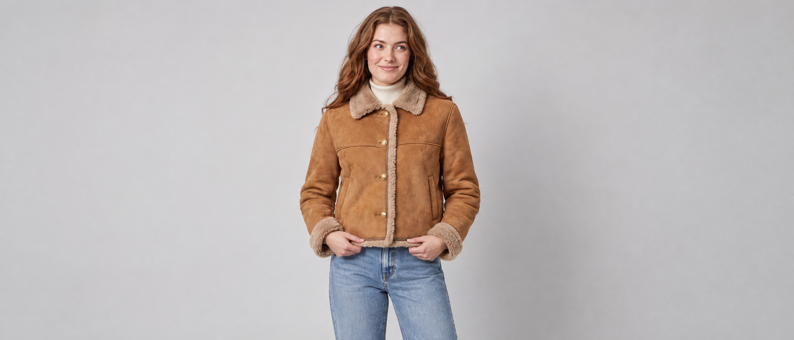 Woman wearing the Voxelvu cropped jacket in a grey studio